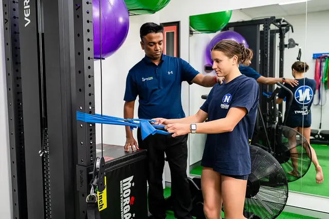 A clinician guiding a resistance-band exercise